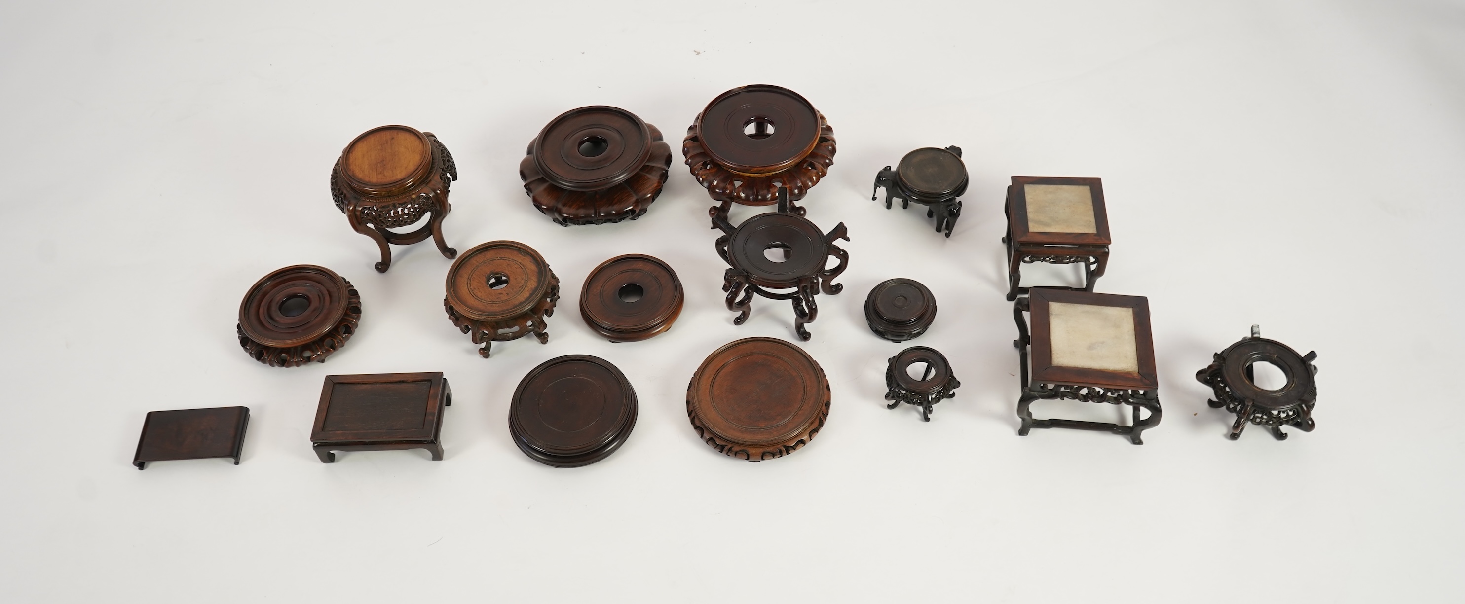 A group of sixteen Chinese hardwood stands together with a Japanese stand, 19th/20th century